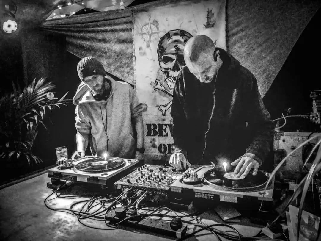 Go Cat DJs — Gareth and Jim at two turntables in front of a pirate flag