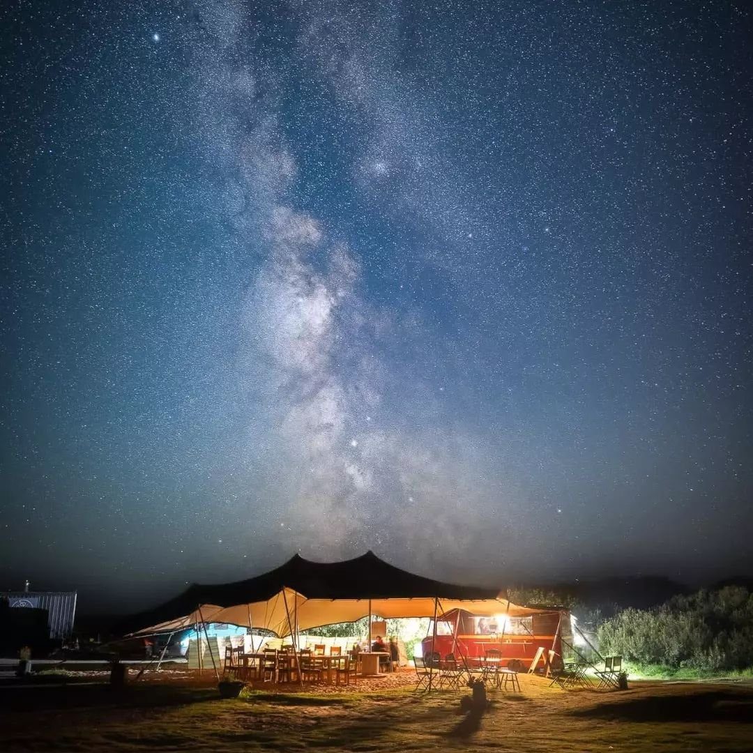 The Dreamboat canopy lit up under a night sky